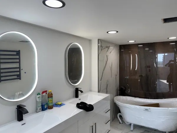 Bathroom with backlit LED mirrors and potlights